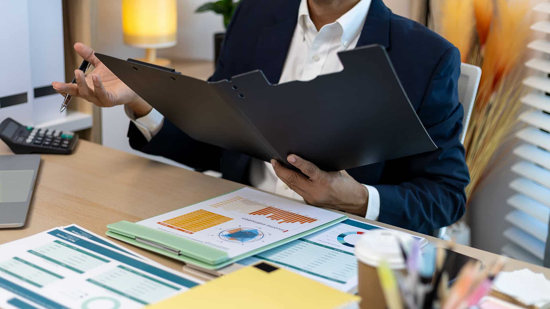 Expert comptable relisant le bilan pour optimiser celui-ci avec son client